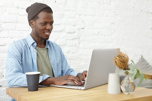 Man using laptop looking happy